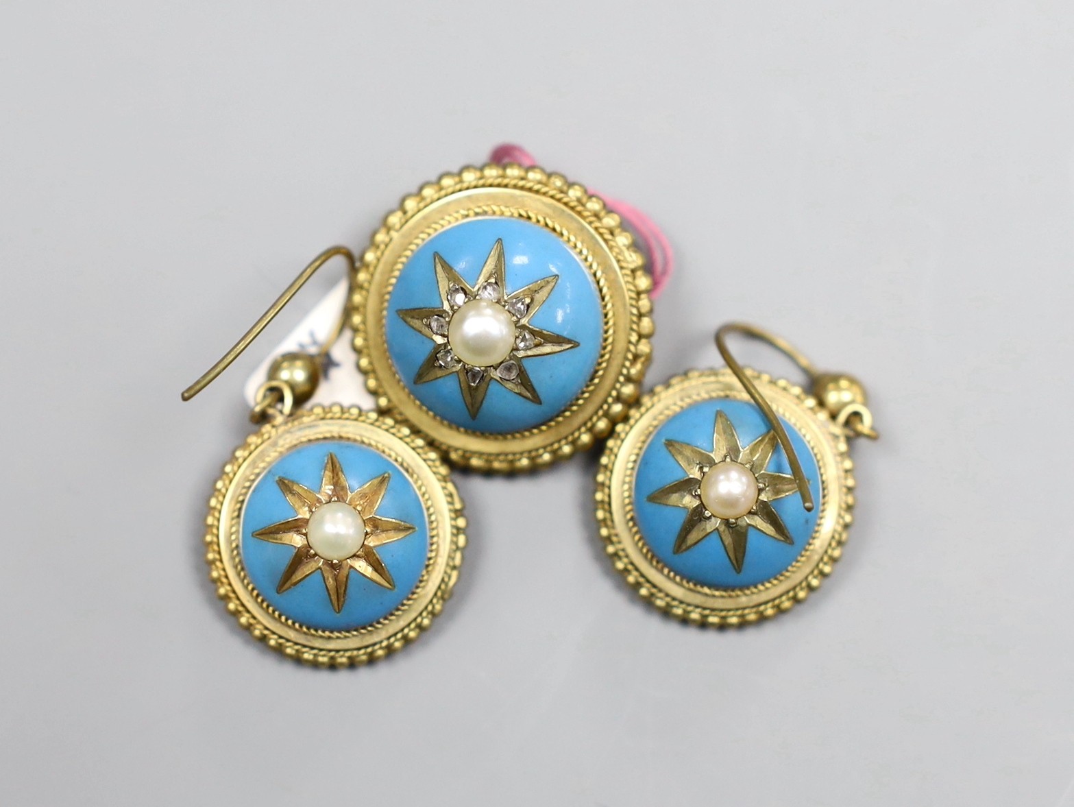 A Victorian 15ct gold pearl, blue enamel and diamond chip set target brooch, with a pair of near matching earrings (earrings lack diamonds), gross 15.9 grams, brooch diameter 2cm